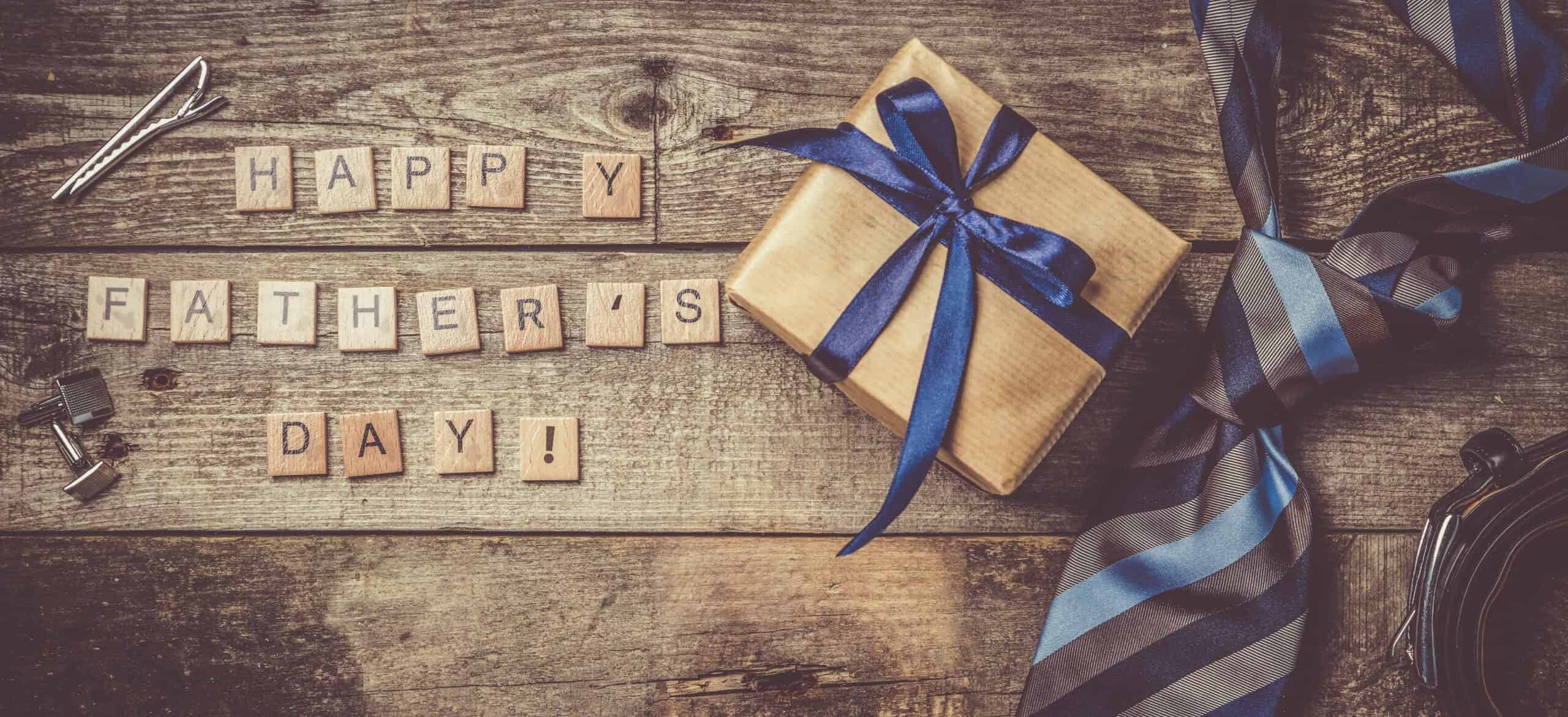 Father's day concept - present, tie on rustic wood background