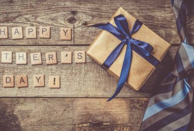 Father's day concept - present, tie on rustic wood background